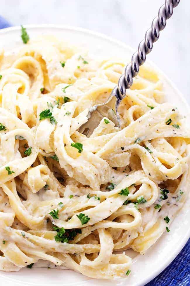 Skinny Fettuccini Garlic Alfredo pasta in a bowl with a fork.