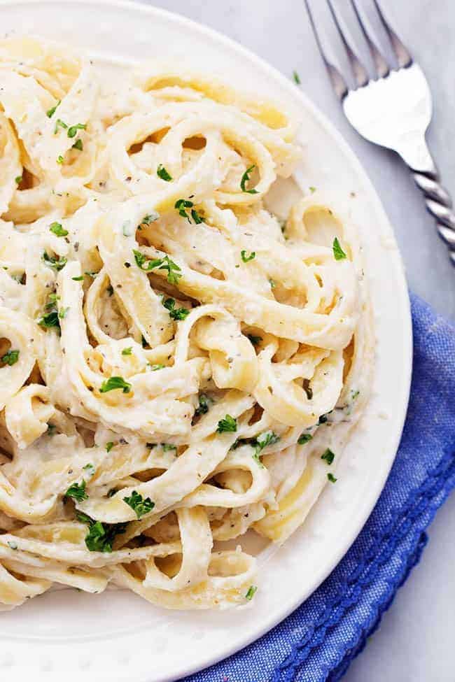 Skinny Fettuccini Garlic Alfredo pasta in a white bowl.
