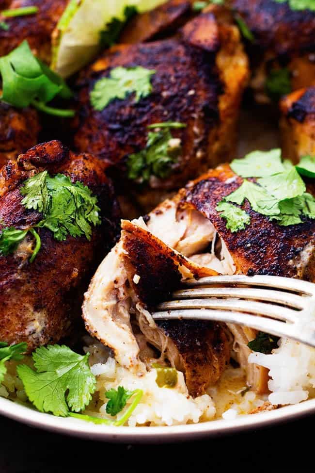 Slow Cooker Creamy Cilantro Lime Chicken over rice in a white bowl.