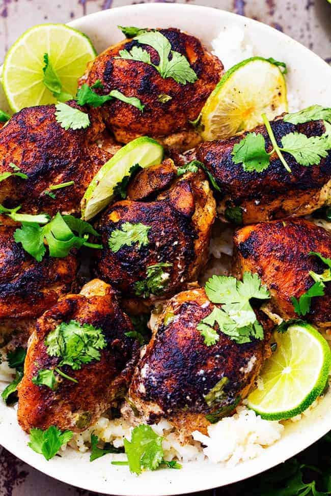 Slow Cooker Creamy Cilantro Lime Chicken over rice in white bowl.