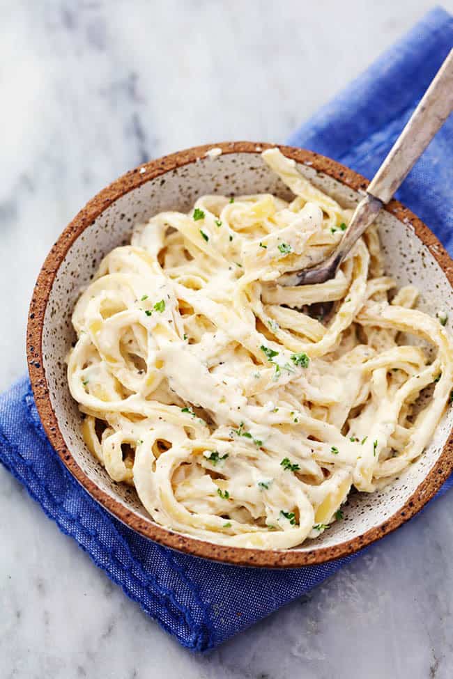 alfredo sauce and pasta in a bowl 