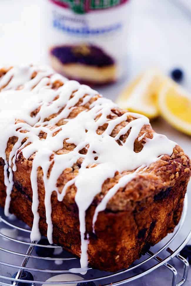 Blueberry pie bread on a cooling rack with fresh lemon glaze.