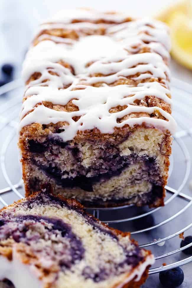 Blueberry pie bread with the lemon glaze on a cooling rack.