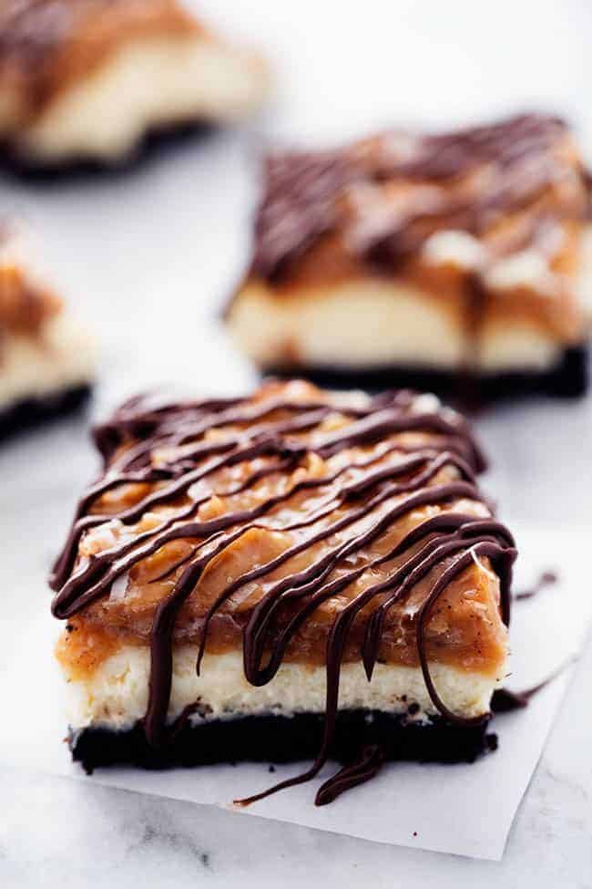 Samoa cheesecake bar on parchment paper.