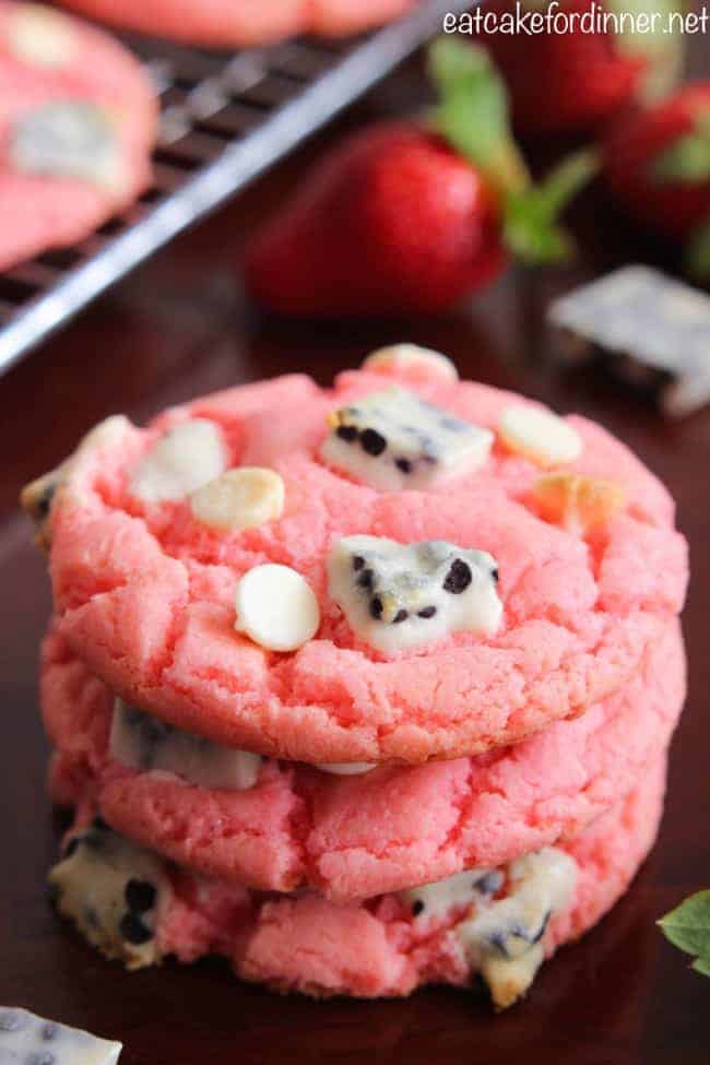 Strawberry Cookies 'n Cream Cookies with fresh strawberries in background.