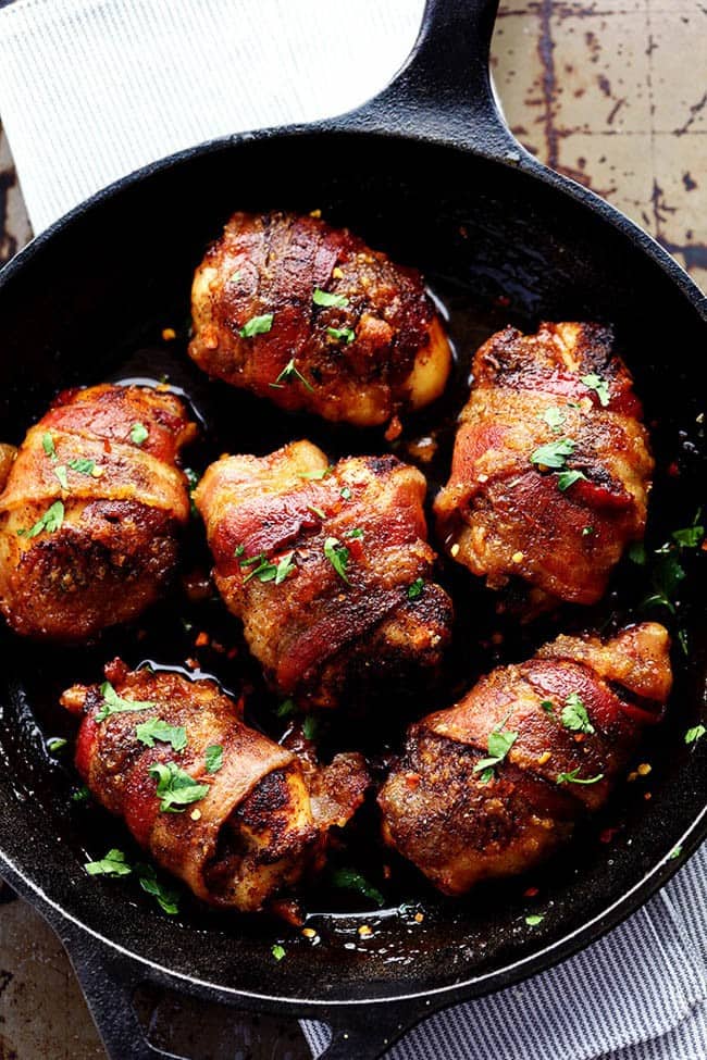 Sweet and spicy bacon wrapped chicken in a skillet.
