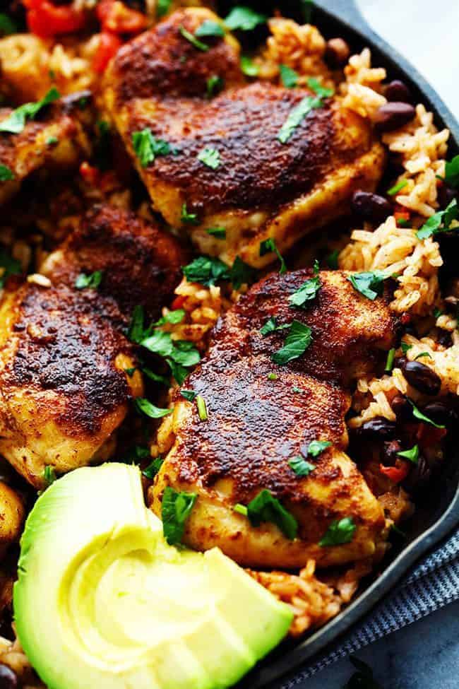 One Pan Southwest Blackened Cajun Chicken with Rice with fresh cut avocado in a large skillet. 