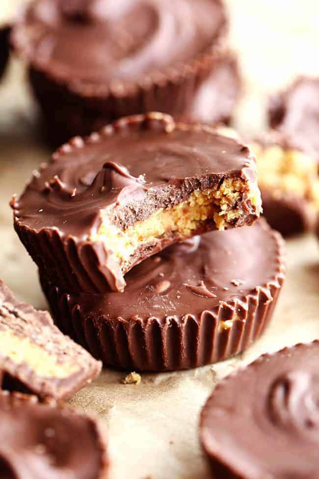 Homemade Reeses peanut butter cups stacked on top of each other one with the bite taken out of it.
