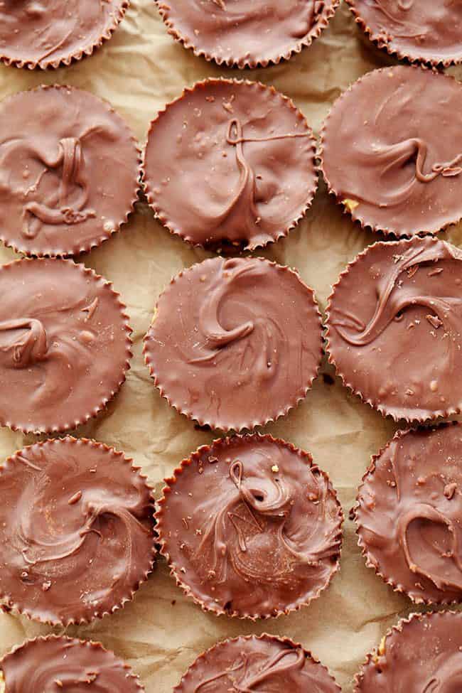 Homemade Reeses peanut butter cups on parchment paper.