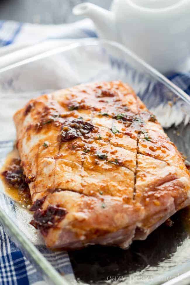 Uncooked Honey Chipotle Pork Roast in a clear pan. 