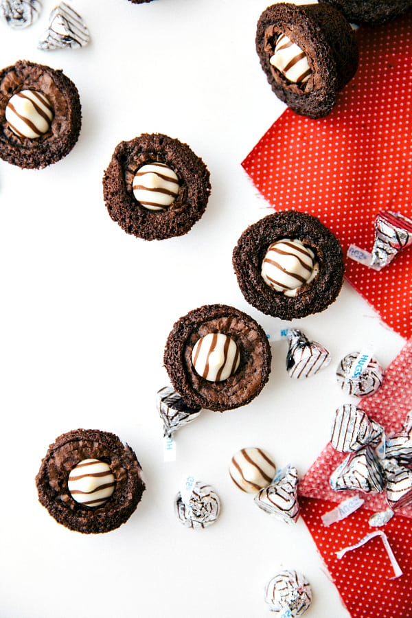 Overhead photo of chocolate filled mini brownie bites with Hersey's Hugs on the table. 