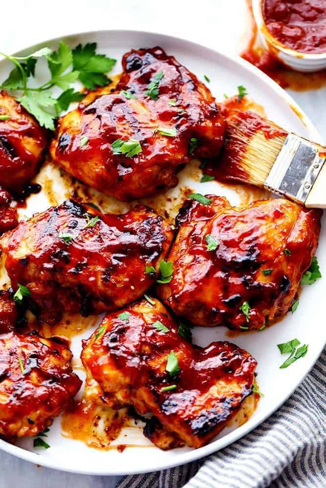 Honey Chipotle BBQ Chicken in a white plate with a sauce brush. 