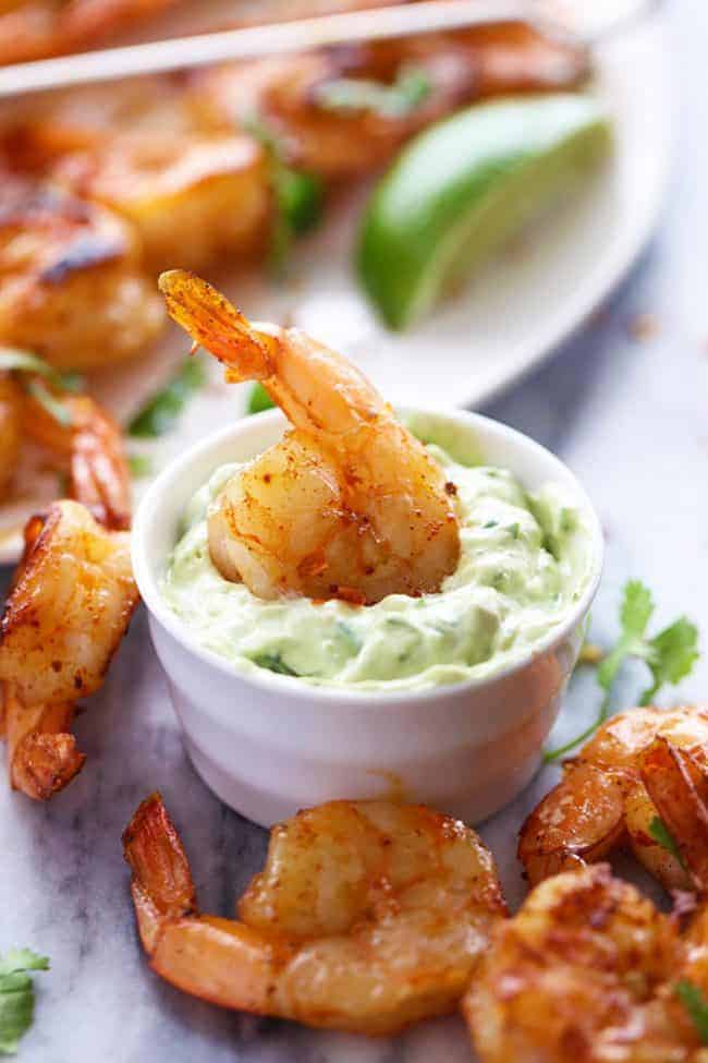 Grilled Spicy Lime Shrimp with Creamy Avocado Cilantro Sauce on a table. 