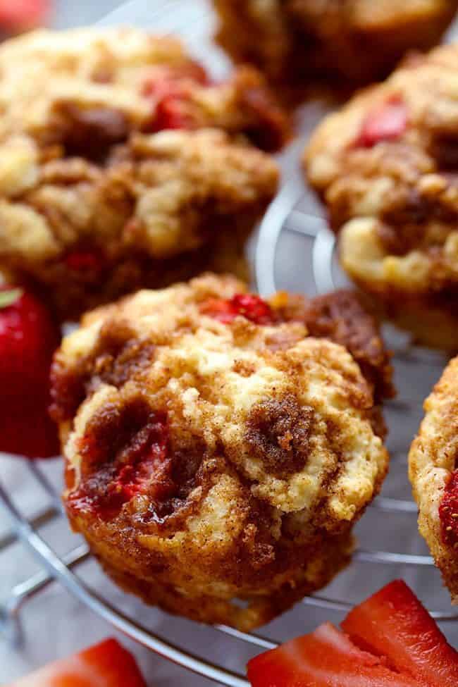 Strawberry Cinnamon Roll Muffins with a Cream Cheese Glaze on a cooling rack. 