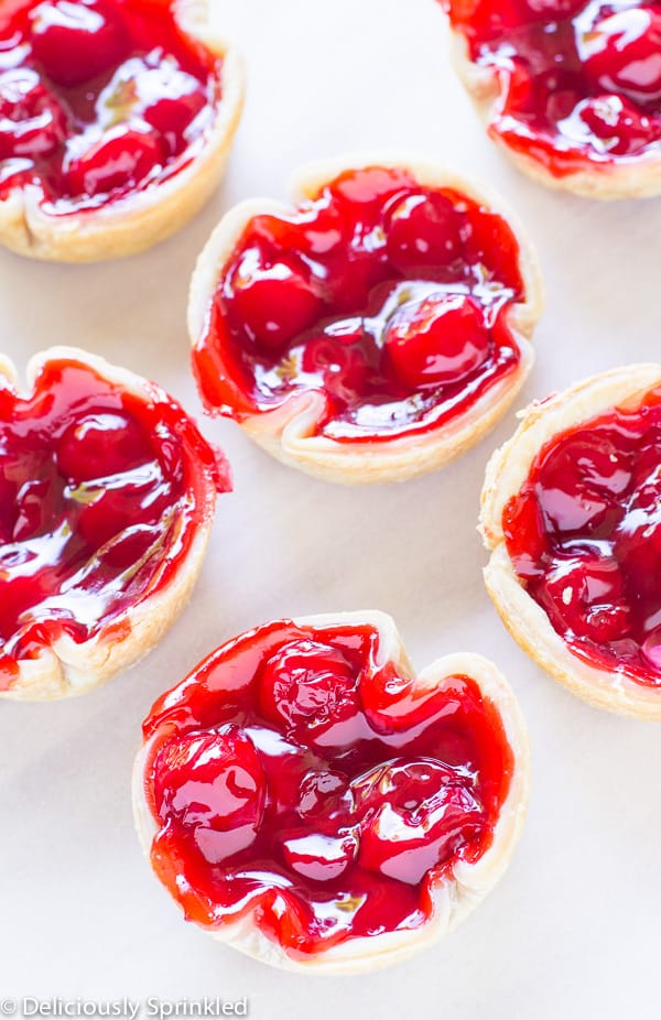 Mini Cherry Pies on a table. 