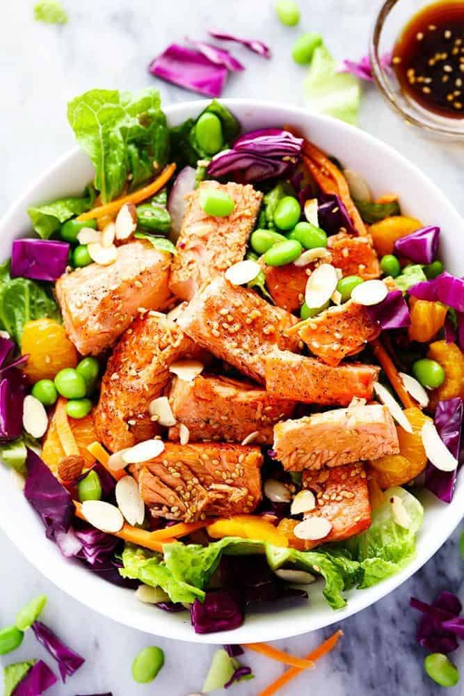 Overhead photo of Asian Pan Seared Salmon Salad in a white bowl. 