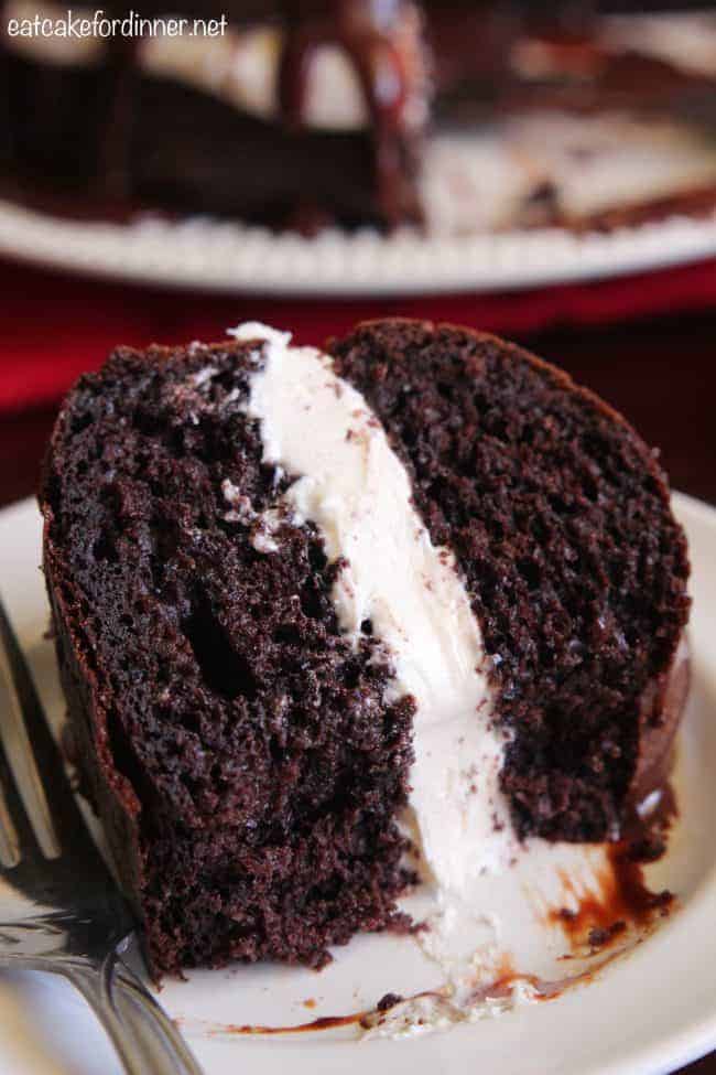 An up close photo fo Chocolate Whoopie Pie Cake on a white plate with a metal fork. 