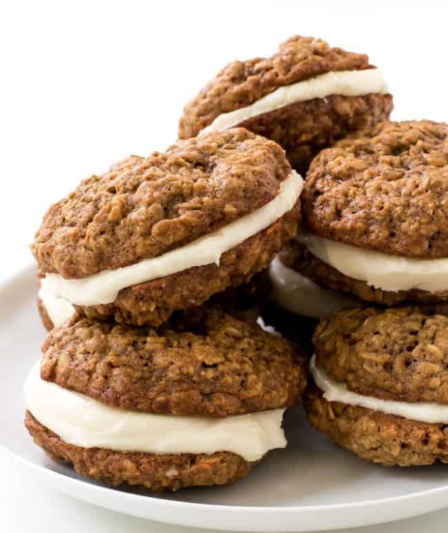 Homemade Oatmeal Cream Pies stacked on each other on a white plate. 
