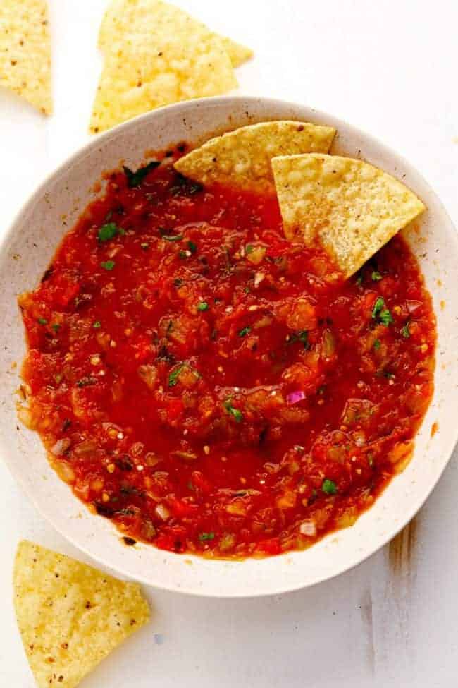 Slow Cooker Restaurant Style Garden Salsa in a white bowl with tortilla ships on the side. 