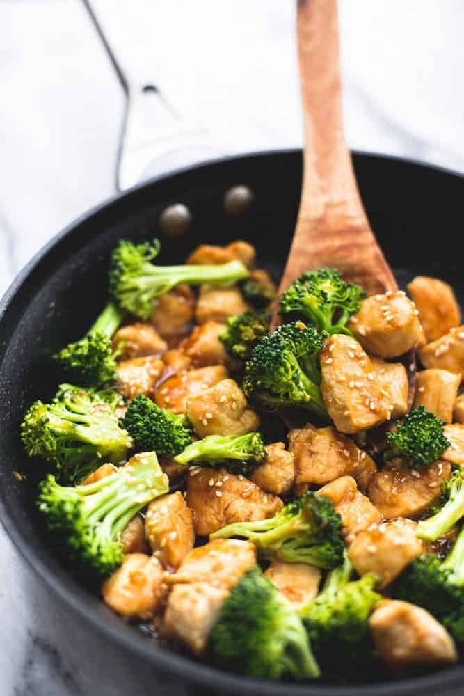 Skillet Sesame Chicken and Broccoli in a large skillet with a wooden spoon. 