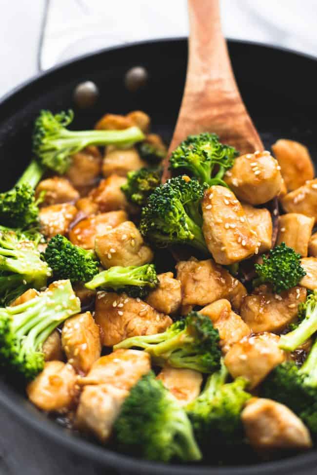 Skillet Sesame Chicken and Broccoli in a large skillet with a wooden spoon. 