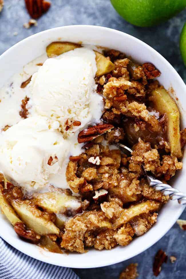 A bowl of Apple Pecan Crisp with vanilla ice cream. 