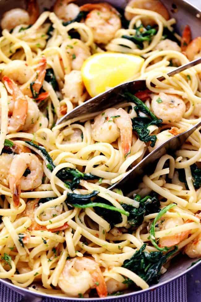 Lemon Garlic Parmesan Shrimp Pasta in a frying pan with a set of tongs. 