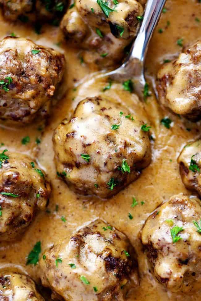 Close up overhead photo of Swedish Meatballs with a metal spoon. 