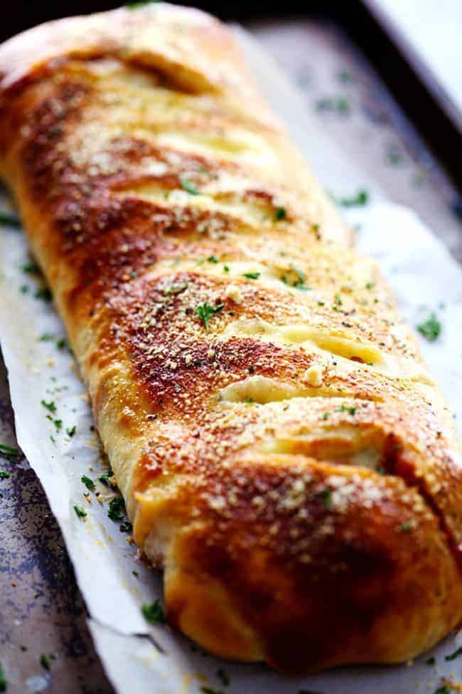 BBQ chicken Stromboli baked on a baking sheet with parchment paper. 