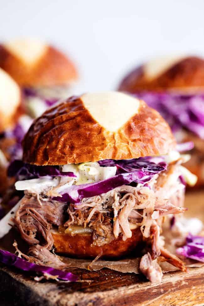 Sweet Carolina pulled pork sliders on a wooden board.