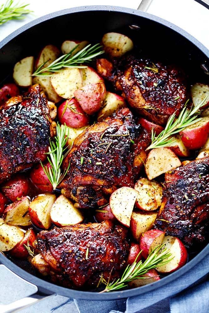 Glazed honey balsamic chicken with potatoes in a large pot.