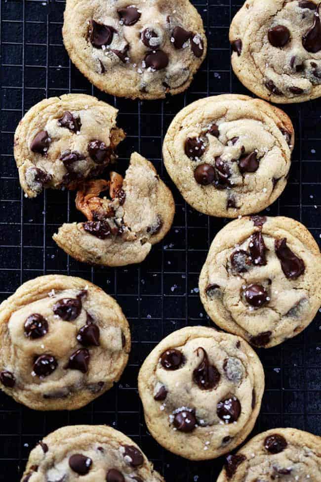 Salted caramel stuff chocolate chip cookies and a cooling rack.