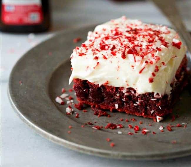 An up close photo of red velvet peppermint brownie with peppermint cream cheese frosting and a great plate. 