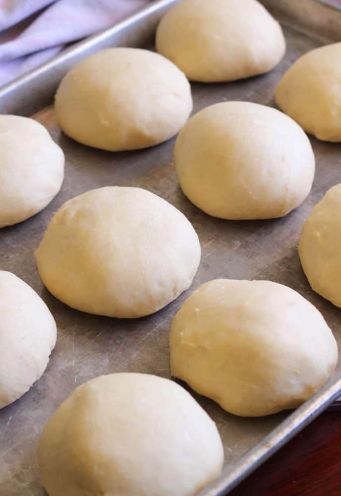 Shaped rolls on a cookie sheet.