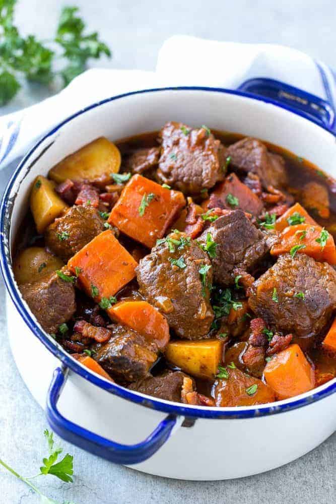 Beef stew with bacon in a large pot. 