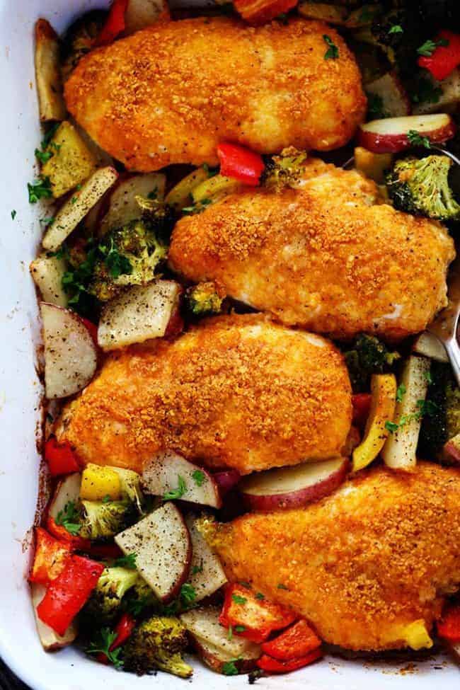 Crispy Parmesan paprika chicken with vegetables and a casserole dish.
