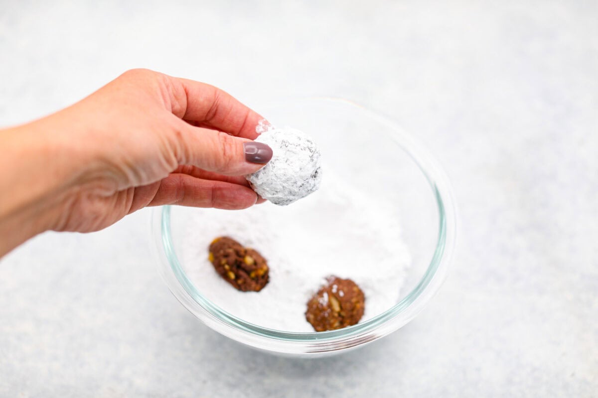 Seventh photo of the baked cookies dipped in powdered sugar.