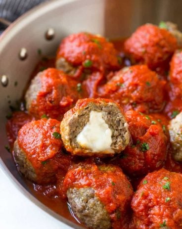 These tender meatballs are stuffed with melty mozzarella cheese - serve as an appetizer or over a big plate of spaghetti!