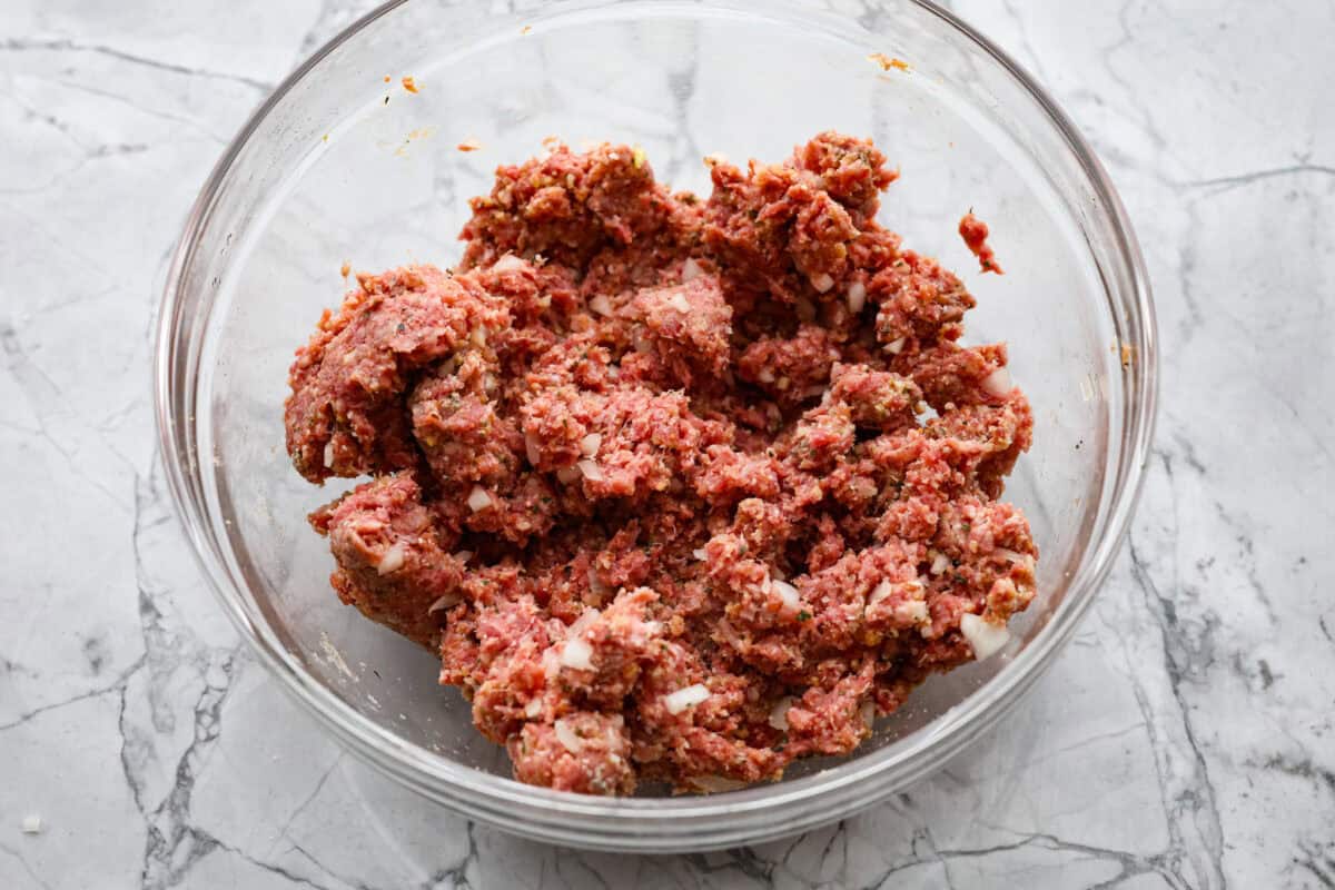 Second photo of the meatball mixture mixed in a bowl.