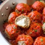 These tender meatballs are stuffed with melty mozzarella cheese - serve as an appetizer or over a big plate of spaghetti!
