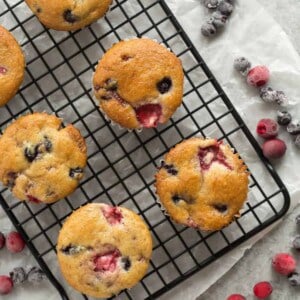 These Fruit Explosion Muffins are packed with berries and have a strawberry surprise in the center! They are just as good as your bakery favorite but made completely from scratch.
