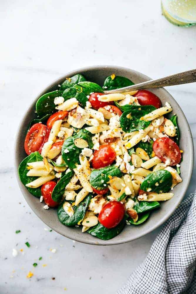 Healthy chicken pasta salad in a grey bowl.