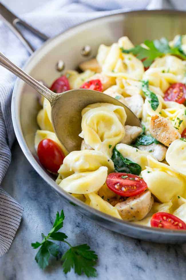 Stirring one pot chicken with tortellini.