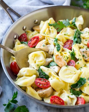 This one pot chicken with tortellini is a family friendly meal that's ready in no time! It's packed full of golden brown chicken, veggies and tortellini, all in a creamy parmesan sauce.