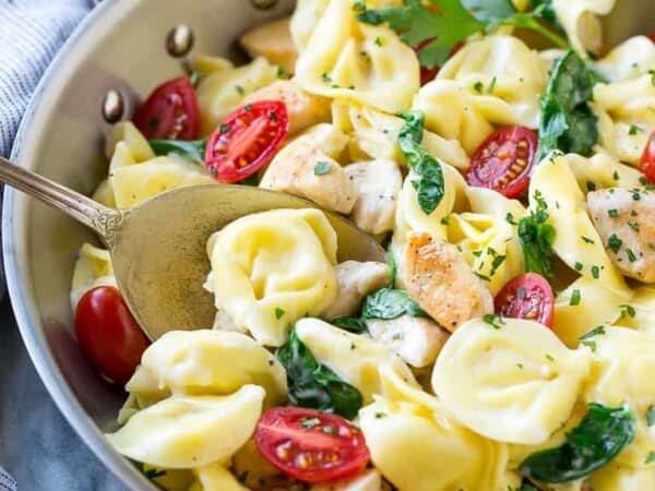 This one pot chicken with tortellini is a family friendly meal that's ready in no time! It's packed full of golden brown chicken, veggies and tortellini, all in a creamy parmesan sauce.