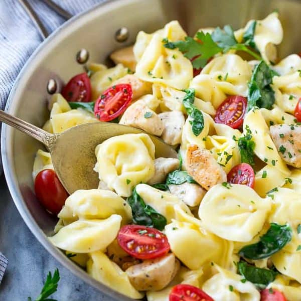 This one pot chicken with tortellini is a family friendly meal that's ready in no time! It's packed full of golden brown chicken, veggies and tortellini, all in a creamy parmesan sauce.