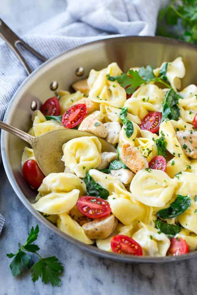 This one pot chicken with tortellini is a family friendly meal that's ready in no time! It's packed full of golden brown chicken, veggies and tortellini, all in a creamy parmesan sauce.