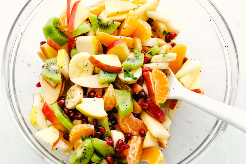 Mixing up the Fruit salad with the poppyseed dressing.