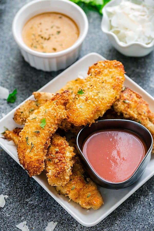 Oven Fried Chicken on a white plate with sauces 