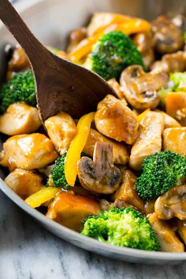 This garlic chicken stir fry is a quick and easy dinner that's perfect for those busy weeknights! Cubes of chicken are cooked with colorful veggies and tossed in a flavorful garlic sauce for a meal that's way better than take out!